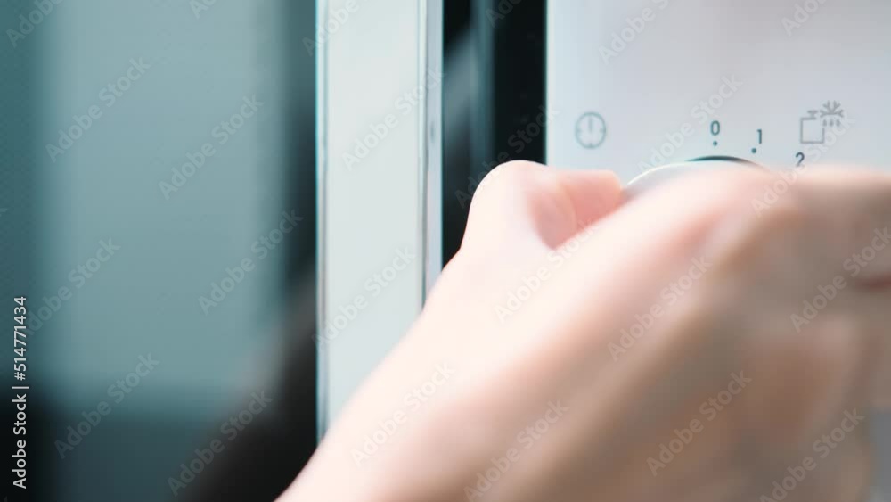 Using a digital keypad to set the microwave oven power level and microwaving time for cooking or reheating. Selecting temperature and cooking timer duration on home kitchen appliance. Using a digital keypad to set the microwave oven power level and microwaving time for cooking or reheating. Selecting temperature and cooking timer duration on home kitchen appliance.