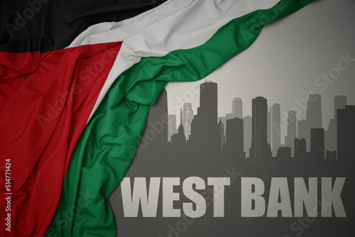 abstract silhouette of the city with text West Bank near waving national flag of palestine on a gray background.3D illustration