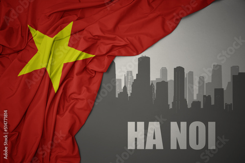 abstract silhouette of the city with text Ha noi near waving national flag of vietnam on a gray background.3D illustration