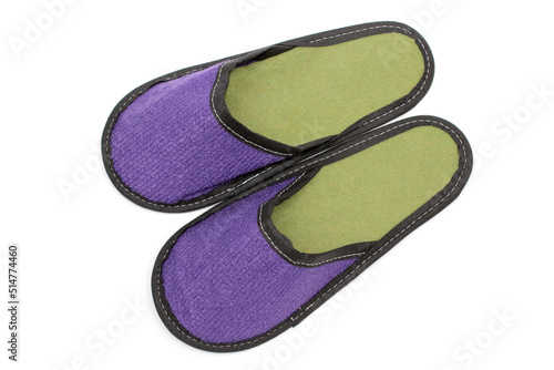 Purple textile slippers with green insole, house slippers isolated on white background, home clothes, top view