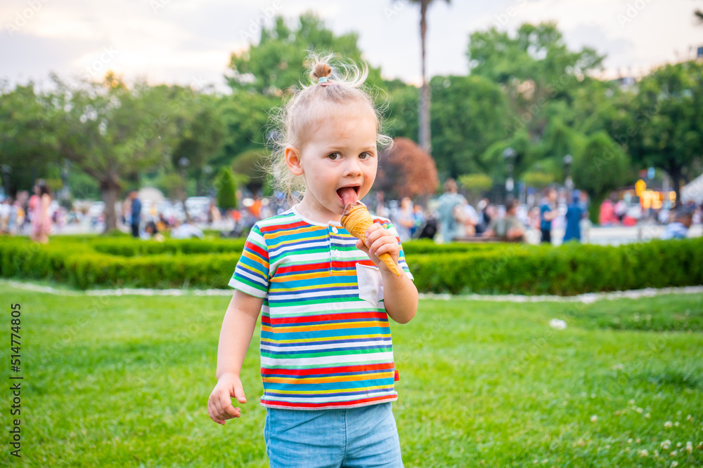Beautiful little girl eating an ice cream in public park of Istanbul, Turkey Beautiful little girl eating an ice cream in public park of Istanbul, Turkey