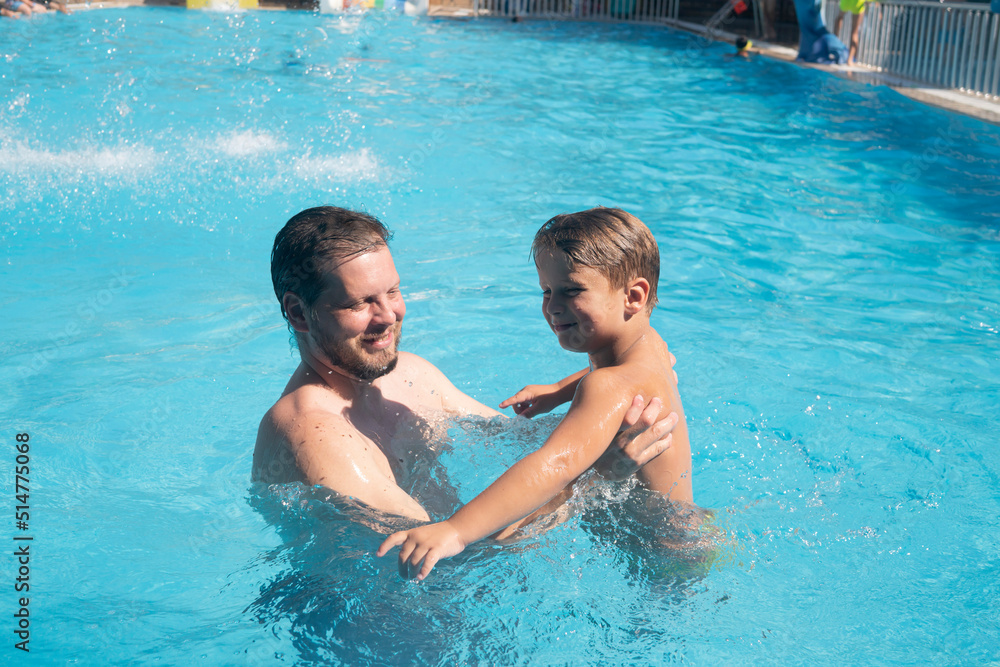 a man father with a child son boy playing in a summer pool