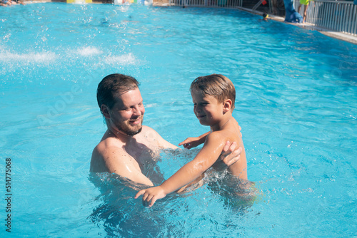 a man father with a child son boy playing in a summer pool © de Art