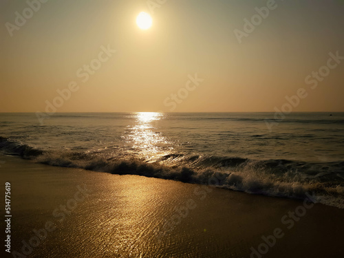 Beautiful beach with sun risen up to the sky lighting the ocean