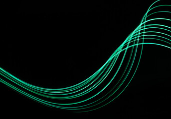 Long exposure light painting photograph of neon colour fairy lights in an abstract swirl pattern against a black background