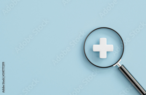 White plus sign inside of magnifier glass with copy space for focus positive mindset  , Healthcare and value added concept by 3d render illustration.