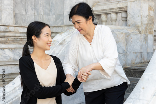 Asian family value with daughter taking care of aged senior mother, filial piety concept