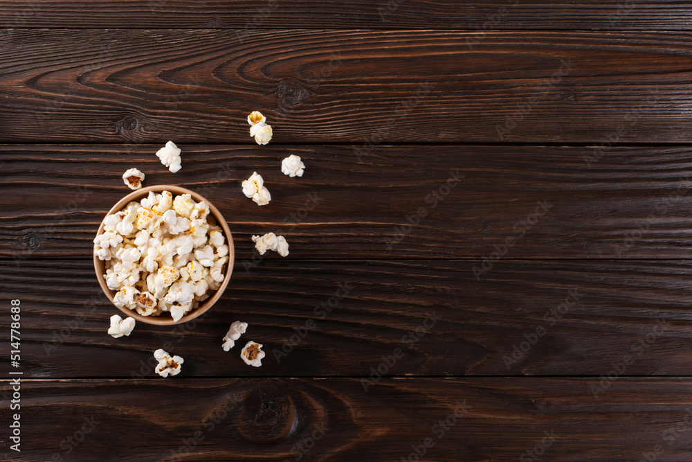 Popped corn snack in paper bucket on kitchen table flat view