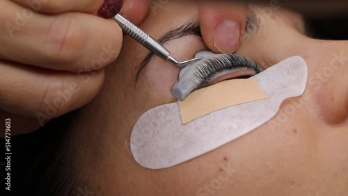 Close-up of a woman's face during an eyebrow thickening and eyelash lamination treatment. concept of professionalism of the lashmaker beautician