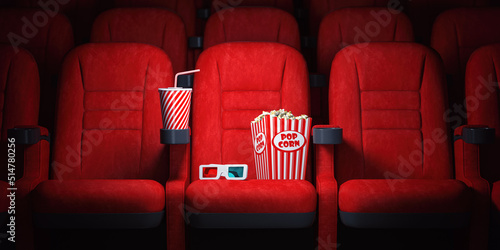Red cinema seats and cola, popcorn and glasses in empty theater. Cinema movie theater concept background. © Maksym Yemelyanov