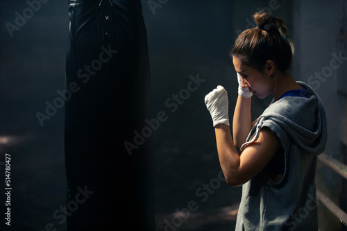 Canvastavla Healthy and strong Asian woman athlete do sport training workout boxing exercise with punching bag in abandoned building