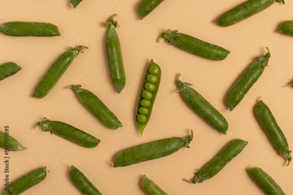 Green peas on a beige background. Top view. Green peas on a beige background. Top view.