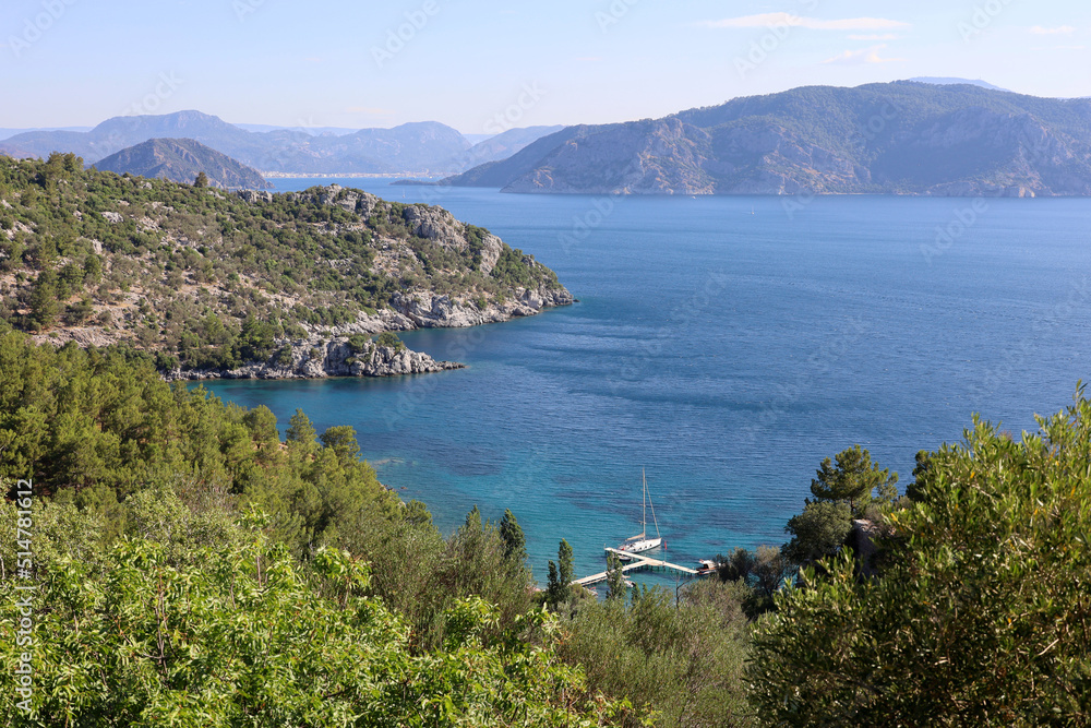 Picturesque view to Mediterranean sea with rocky cliff, bays and islands. Summer coast of Turkey in Marmaris region with transparent water and green mountains
