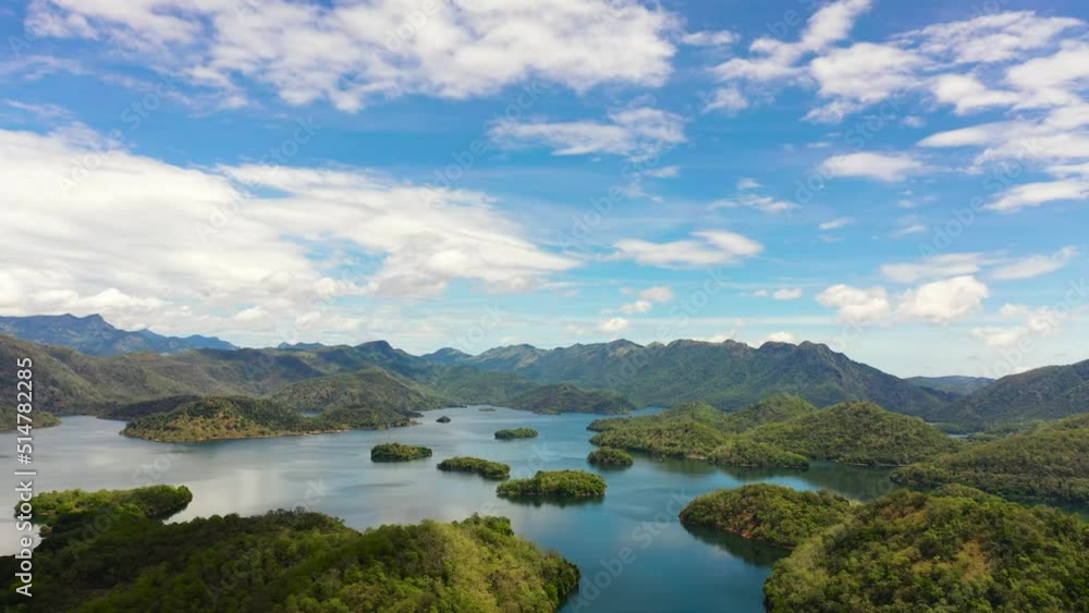 Aerial view of mountain lake among hills with tropical vegetation and blue sky with clouds. Randenigala reservoir, Sri Lanka. Aerial view of mountain lake among hills with tropical vegetation and blue sky with clouds. Randenigala reservoir, Sri Lanka.