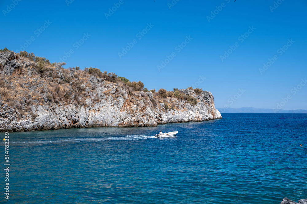 Speedboat sails in calm sea at Mani Laconia, Peloponnese. Destination Greece sport activity leisure