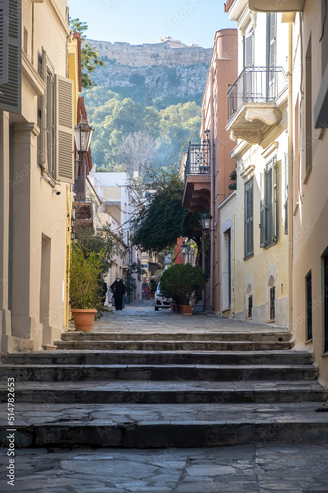 Greece. Plaka, old house, narrow stair and alley. Under view of Acropolis of Athens rock. Vertical