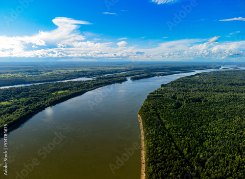 Vasyugan swamp from aerial view. Ob river top view. Pine forest on the river shore. The biggest mire in the world. Taiga forest. Siberia, Russia