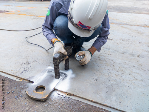 Inspector checking defect in welded with process Magnetic Particle Testing(MT) of Non-Destructive Testing(NDT) at the industrial factory.