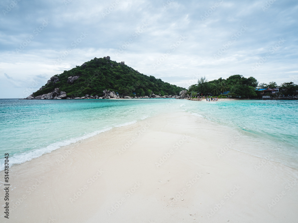 Scenic view of Koh Nang Yuan Island iconic white sand bar between crystal clear turquoise sea water with island mountain background. Near Koh Tao Island, Surat Thani, Thailand.