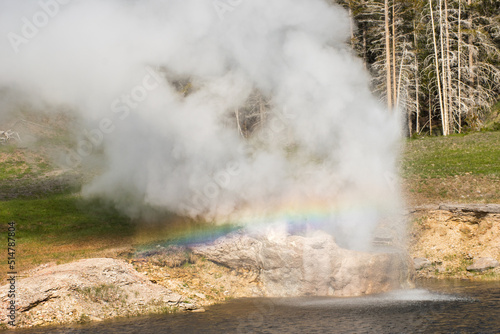 Riverside Geyser with a rainbow in Yellowstone National Park, horizontal