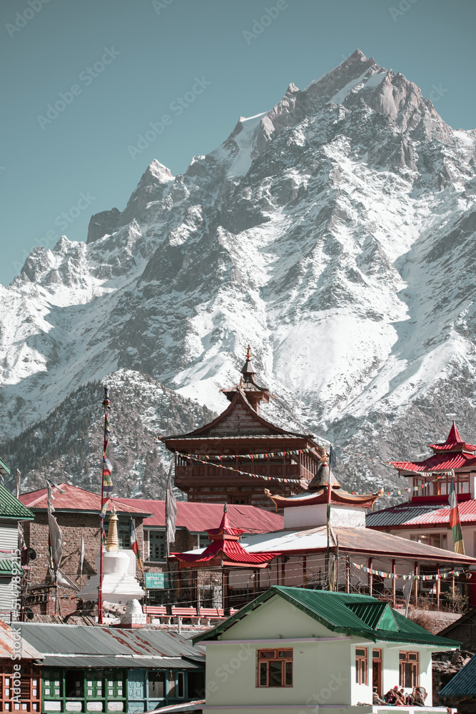 Temple against snowy mountains