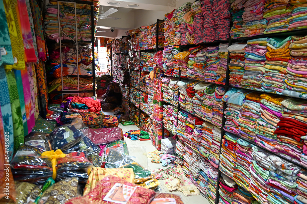 Saree store selling various types of sarees in shop. Ethnic woman clothing in India.