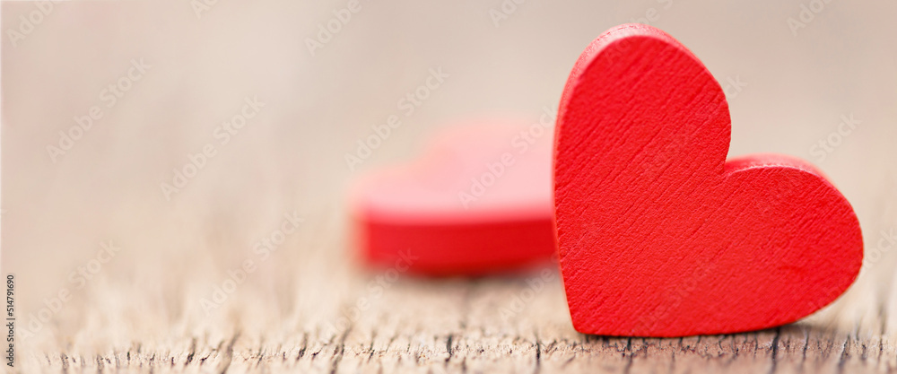 Fototapeta premium Two small red hearts made of wooden on bright white lights bokeh background. Valentine day background