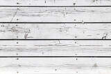 An old damaged wooden wall painted in white as a background