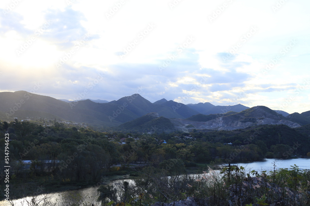 Fototapeta premium sunset in the mountains near the river