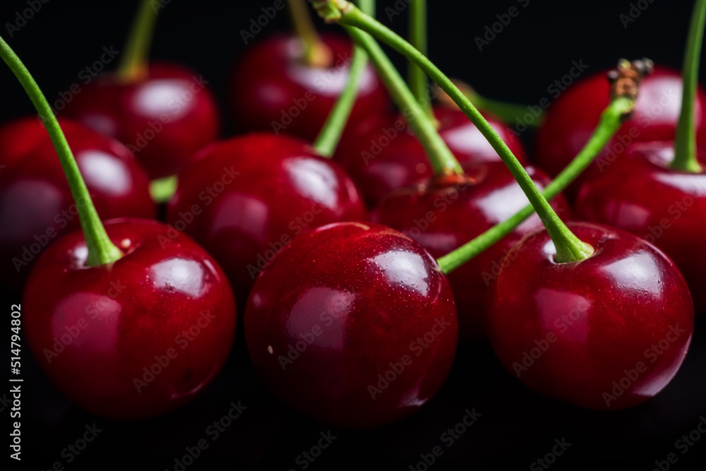 Red cherry berries on a black background with mirror. Three cherries Red cherry berries on a black background with mirror. Three cherries