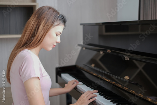 Portrait of beautiful woman playing piano. asian Young woman playing piano.