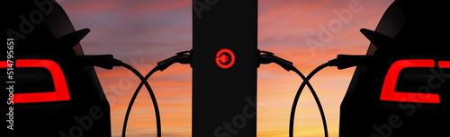 Silhouettes of electric cars and charging station on a background of sunset sky