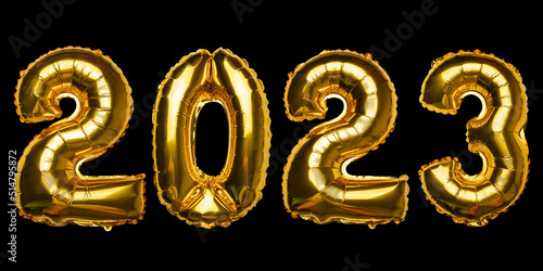 2023 Happy New Year concept from golden foil balloon on black