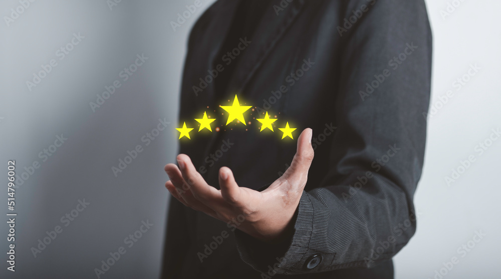 Customer service evaluation and satisfaction survey concepts. Hand hold the five stars rating excellent feedback icon, Rated a very good review or happy customer....