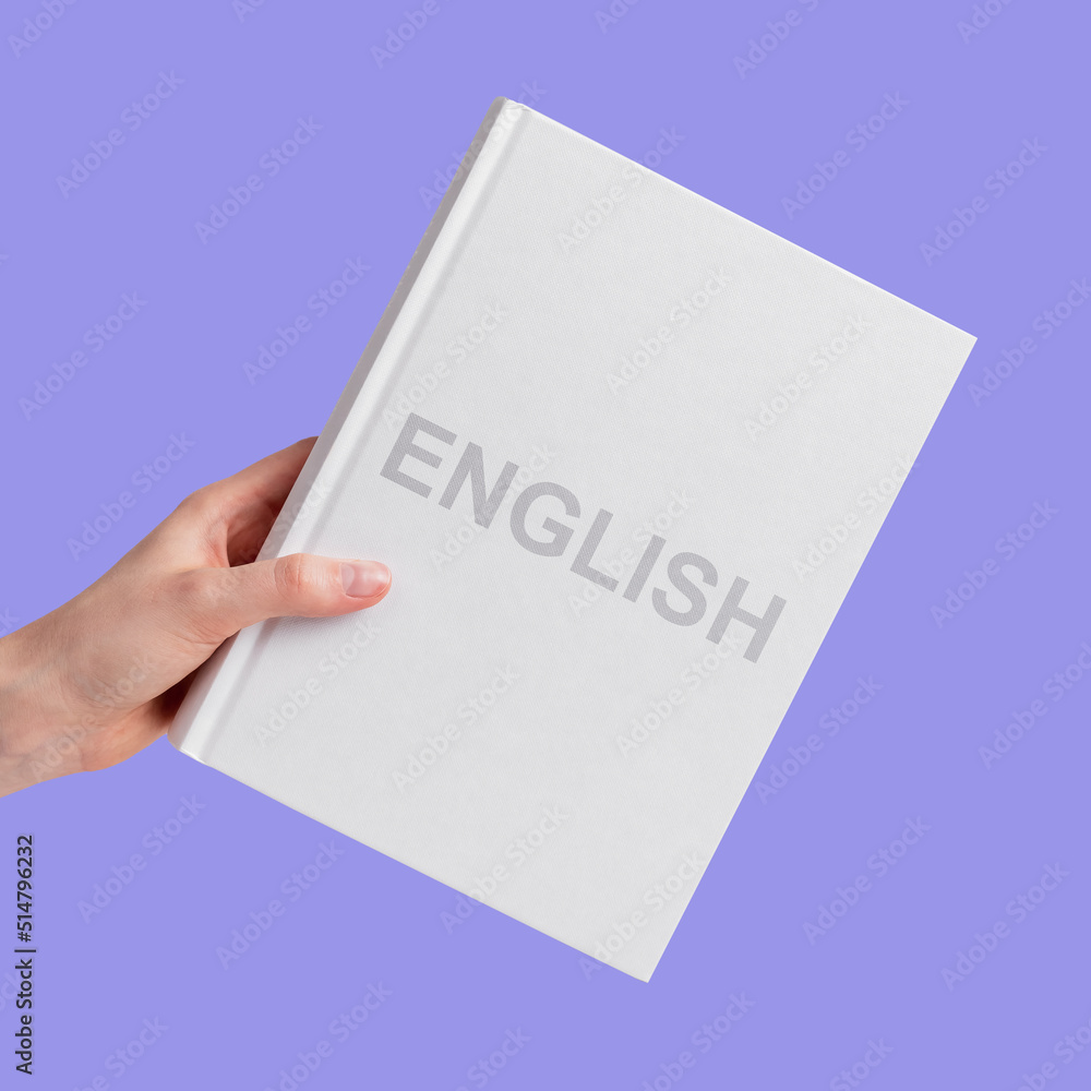 English language book in female hand closeup. High quality photo English language book in female hand closeup. High quality photo