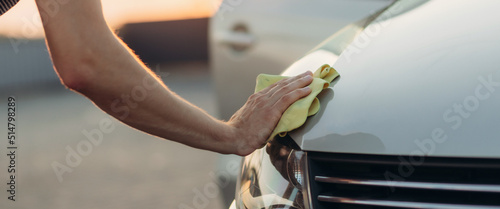 Hand with a wipe microfiber the car polishing