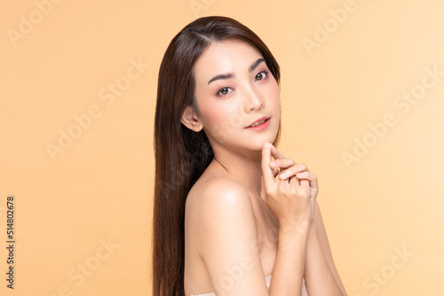 Beautiful Asian woman smile with clean and fresh skin Happiness and cheerful with positive emotional,isolate on Beige background. Young female proud with her beauty skin.Beauty Cosmetics and Self care