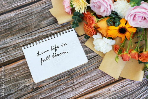 Note pad with text live life in full bloom with mixed flower bouquet