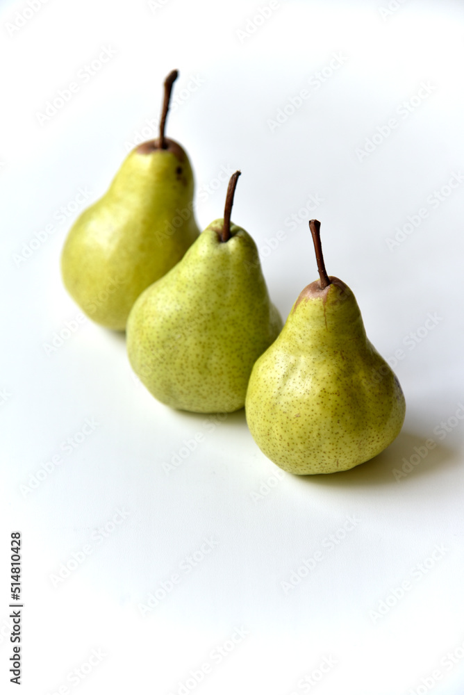 Three green juicy pears on a white background Three green juicy pears on a white background