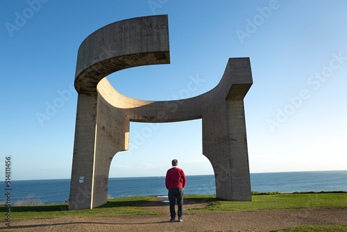 Hombre observando la escultura Elogio del horizonte de Chillida en Gijón, Asturias. photo