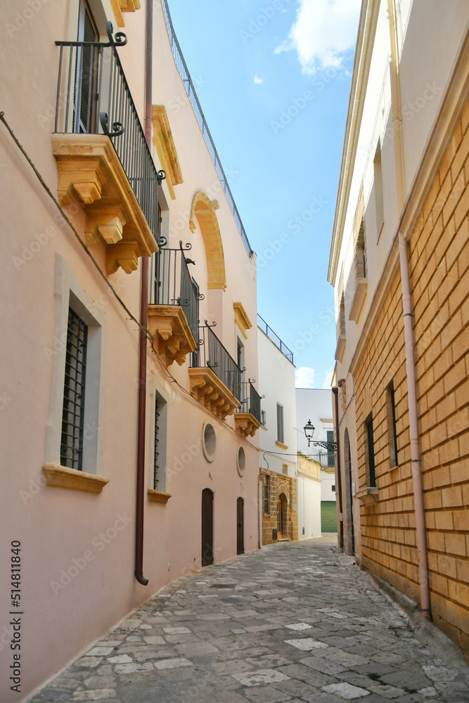 A narrow street between the old houses of Uggiano, a medieval town in the Puglia region of Italy.
