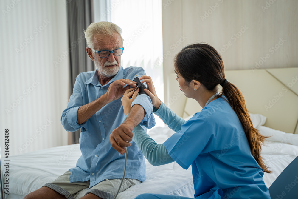 Fototapeta premium Nurse measures blood pressure to seniors patients at home,Concept of Health Care,Medical Consultant.