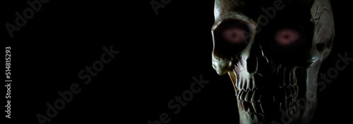 Frightening purple eyes in a human skull