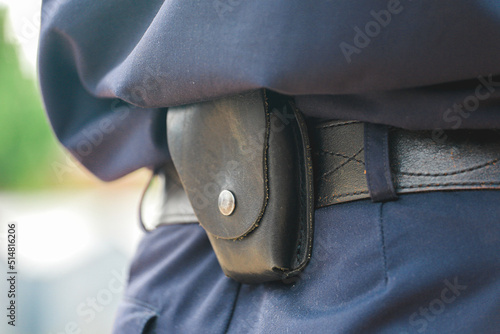 Formation of the Russian police squad rear view, side view. A policeman with a pistol holster, handcuffs, a taser and a holster.A law enforcement officer wears a duty belt, with a pistol, handcuffs.  photo