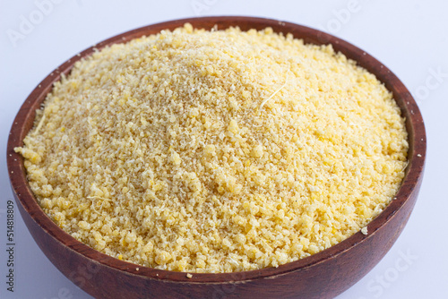 Nigerian yellow and white garri in a wooden bowl. photo