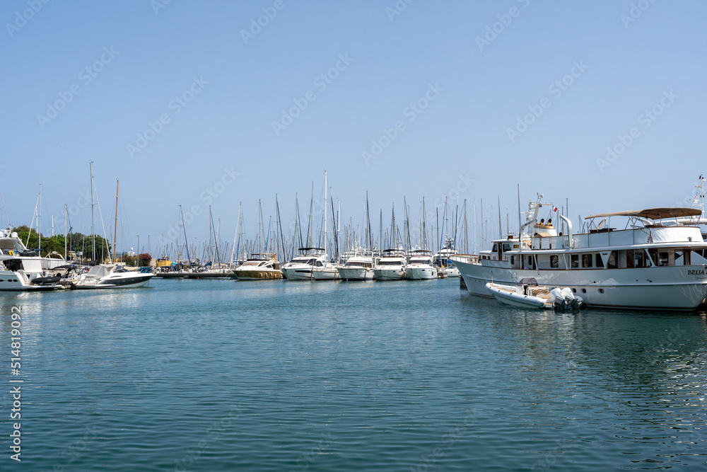Sleek and modern sailboats and motor boats in a central marina in Antibes, France. Yachts and speed boats in the port. Sleek and modern sailboats and motor boats in a central marina in Antibes, France. Yachts and speed boats in the port.