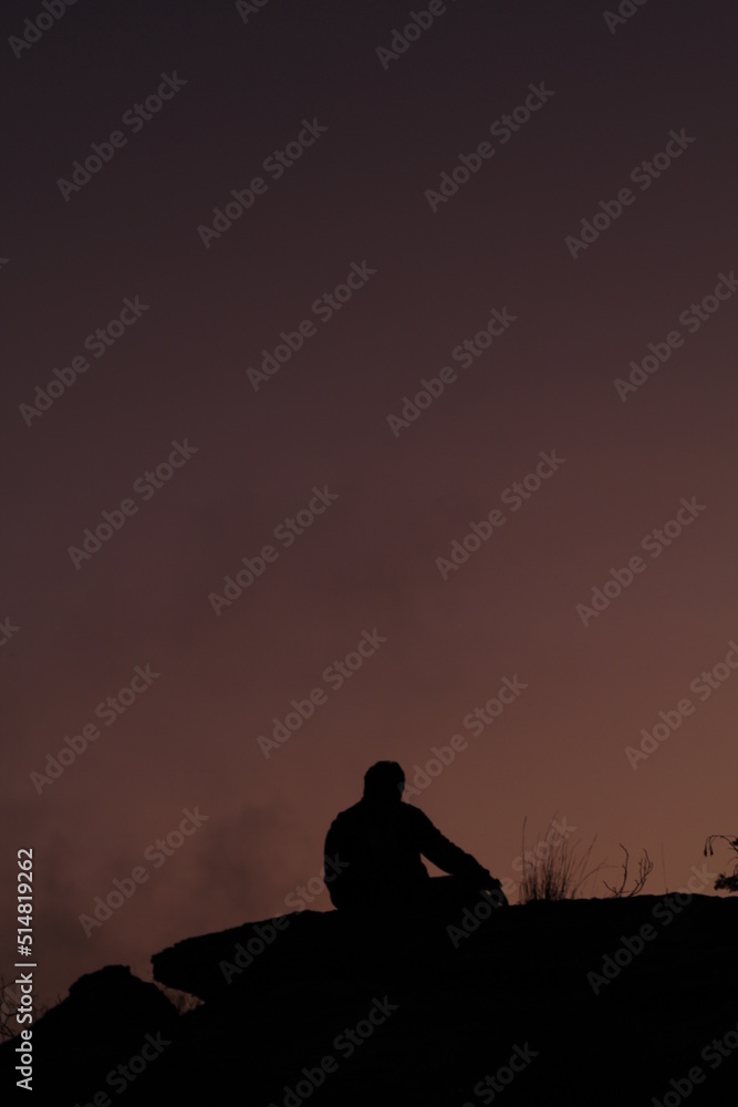 silhouette of a person watching the sunset
