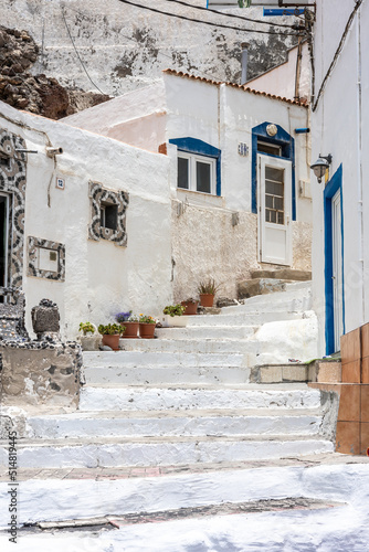 Charming white and blue village with steep staircases © Damian