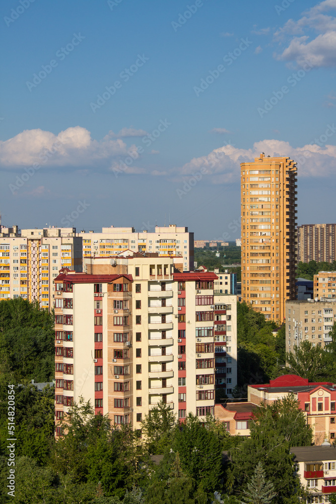 Urban landscape - modern high houses of Reutov in the Moscow region on a bright sunny summer day and a space for copying