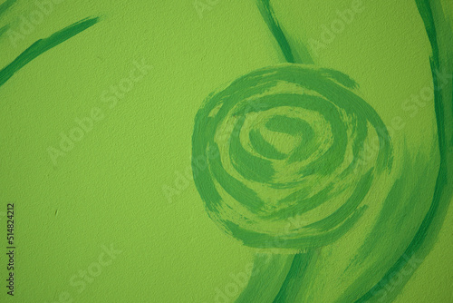 floral pattern painted on the wall, green abstract crooked shape on green light background, green wallpaper